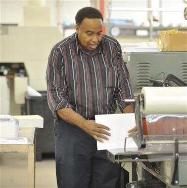 Man (Roy) works at shipping station.